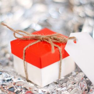 a red and white gift box with a white tag